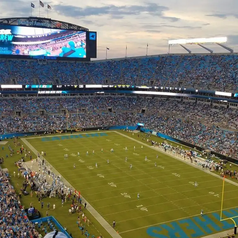 a football stadium with people in the stands with Bank of America Stadium in the background